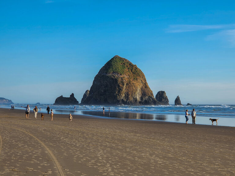 Haystack Rock and the adjacent beach in Cannon Beach, Oregon in June 2023.
