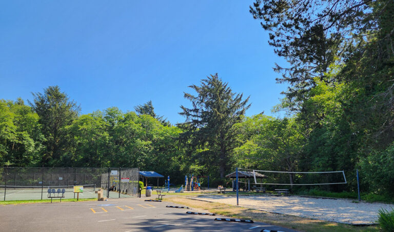 a neighborhood park with tennis and volleyball courts on a sunny day in Manzanita, Oregon