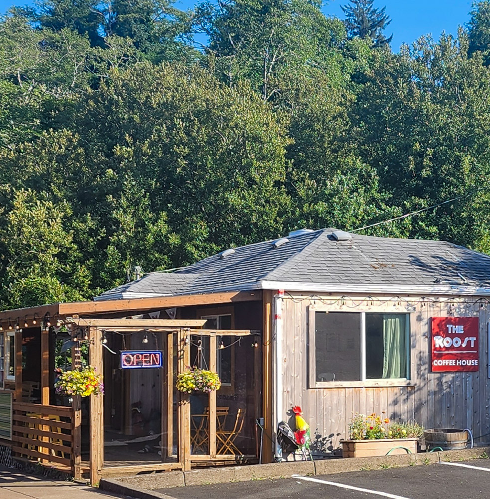 a coffee house exterior with charming outdoor deck in Wheeler, Oregon