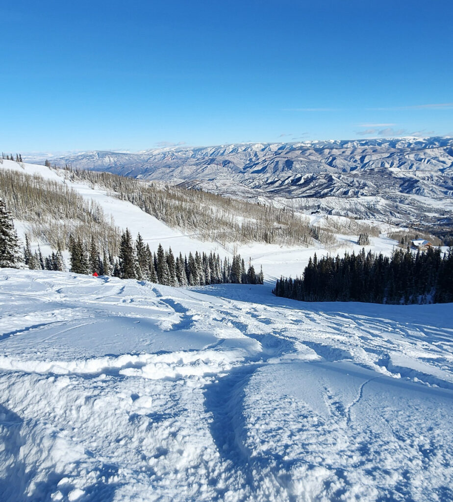 tracks in fresh powder at Snowmass ski area in Colorado