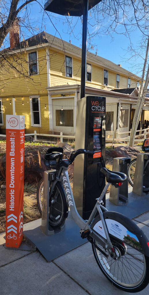 a wecycle bike docked in a rack in downtown Basalt